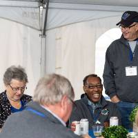 The class of 1968, enjoying conversation with one another at the Alumni Homecoming Tailgate.